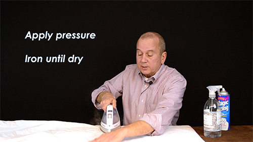 Place a towel between your sheets & the ironing board, then iron with a bit of pressure