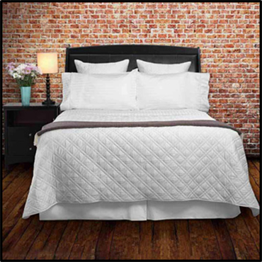 Quilted coverlets are a great top of the bed piece in the Summer